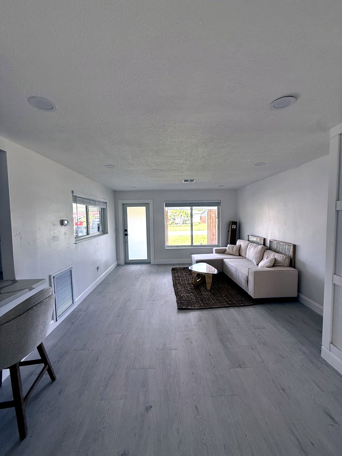 Bright living room with impact sliding glass doors