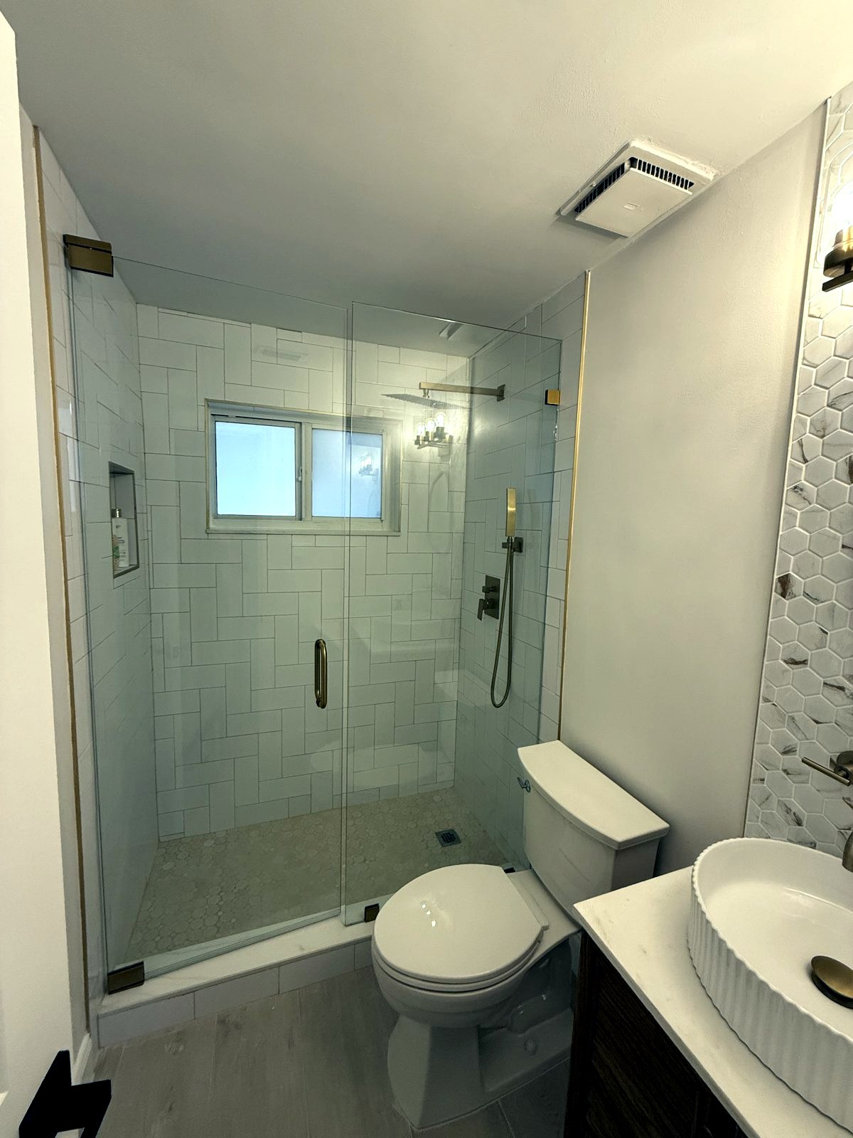 Frameless glass shower enclosure
